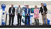 Picture of four men and one woman cutting a blue ribbon