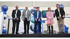 Picture of four men and one woman cutting a blue ribbon