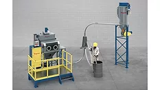 Picture of a man standing next to a vacuum conveying system