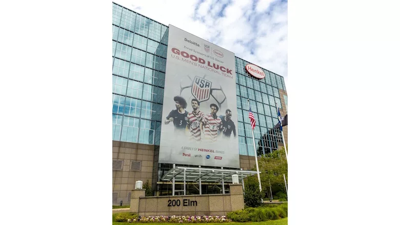 Picture of a buiding with a large banner with soccer players