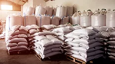 A large group of bags in a warehouse. 