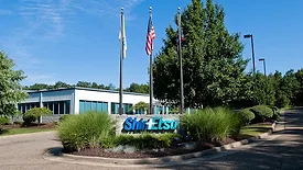 Picture of the exterior of a building with a sign in the front.