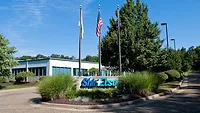 Picture of the exterior of a building with a sign in the front.