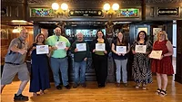 Image of eight people holding awards