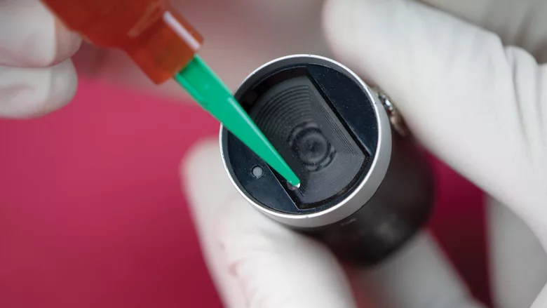 Picture of an adhesive being applied with a syringe