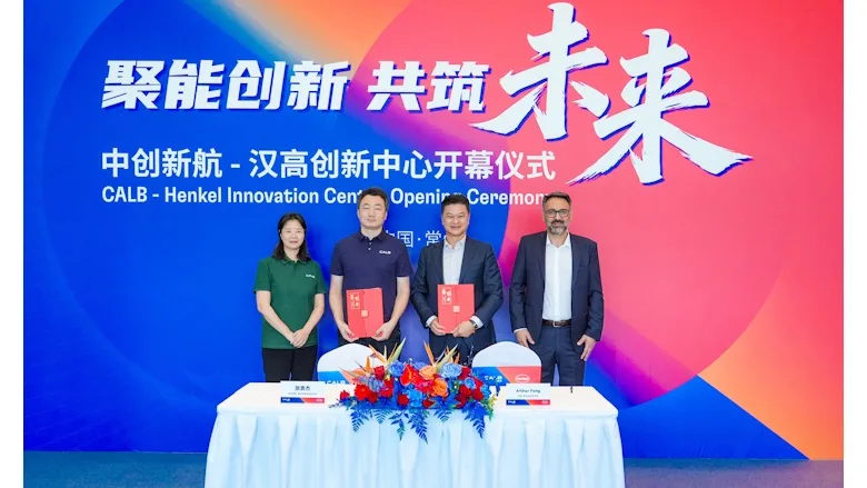 Picture of four people standing holding folders