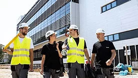 Picture of four construction workers in yellow vests