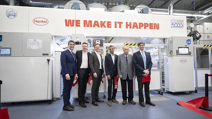 Picture of five men standing in front of a machine