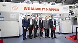 Henkel Packaging Competence Center Picture of five men standing in front of a machine