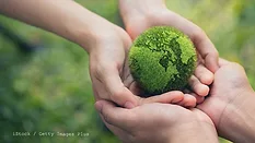 Image of hands holding green globe