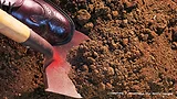 Photo of shoe on shovel breaking into dirt