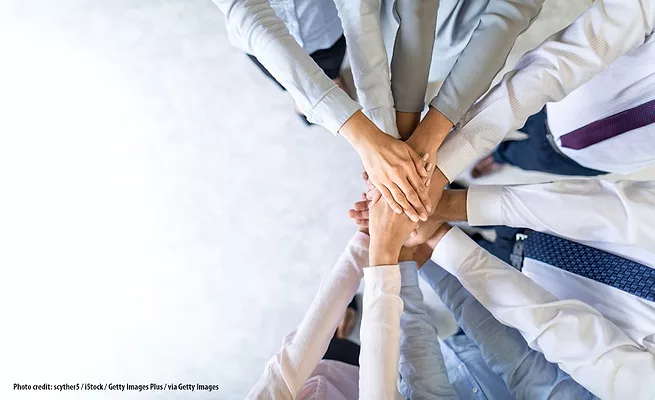 Partnership-or-merger-GettyImages-1174511028.jpg Photo of people's hands coming together like teamwork.