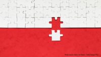 white puzzle piece added to larger puzzle on red background