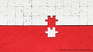 acquisitions-GettyImages white puzzle piece added to larger puzzle on red background